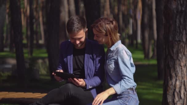 Couple using modern device and laughing outdoor. - Footage, Video