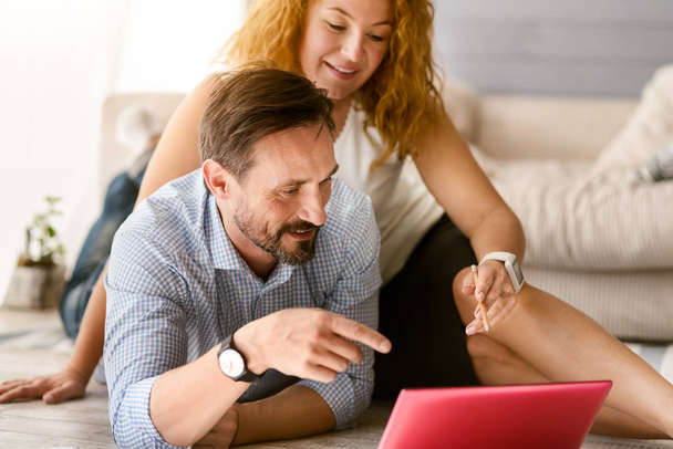 Inventive positive couple working together at home - Photo, image