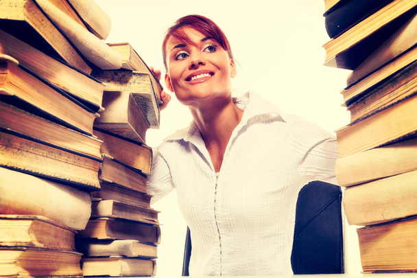 Education concept. Beautiful young woman with stack of books on white background - Foto, Imagen
