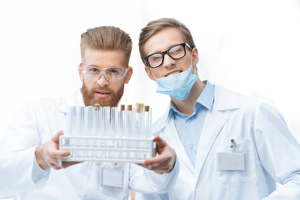Chemists holding test tubes - Foto, imagen