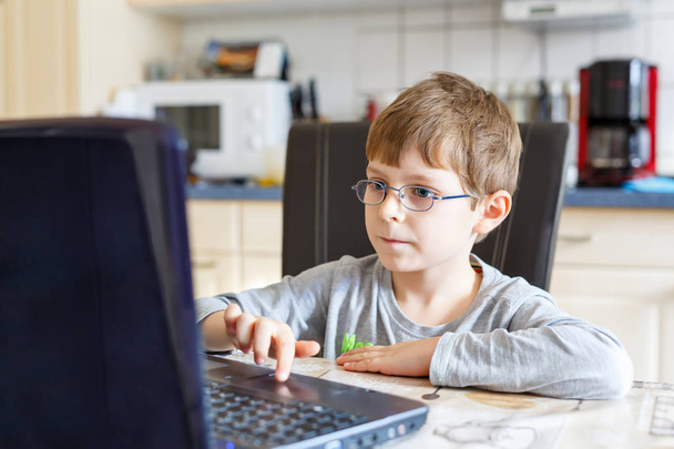 kid boy with glasses surfing internet and playing on computer - Photo, Image