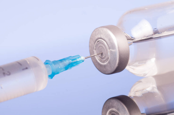 Medical syringe with the needle in the vial - Photo, Image