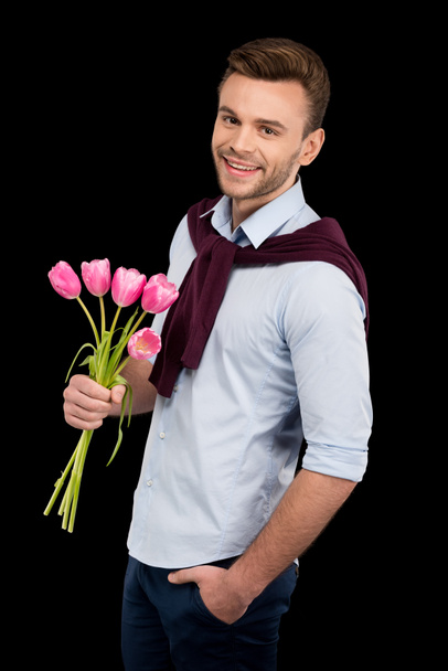 Homme tenant des tulipes
 - Photo, image