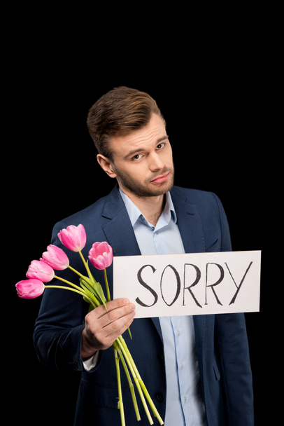 Man with tulips and sorry sign - Φωτογραφία, εικόνα
