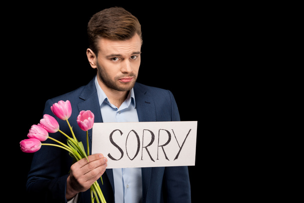 Человек с тюльпанами и знаком сожаления
 - Фото, изображение