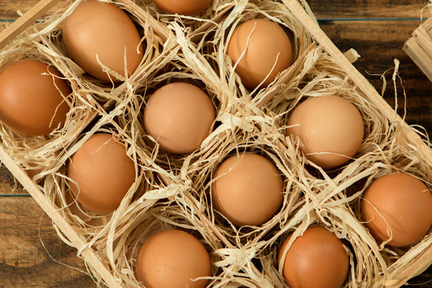 raw eggs in wooden box - Photo, Image
