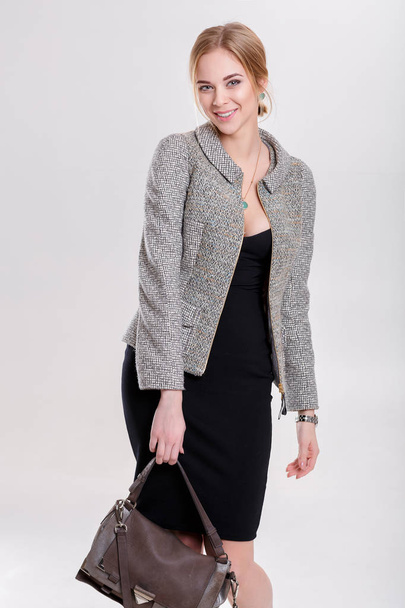 beautiful business woman blonde in black dress, jacket and purs - Fotó, kép
