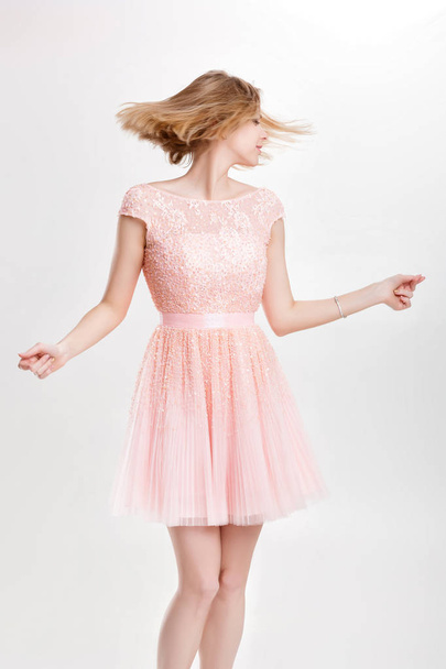 beautiful blond woman in a pink cocktail dress dancing and havin - Foto, immagini