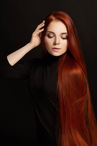 Sexy beautiful redhead girl with long hair. Perfect woman portrait on black background. Gorgeous hair and deep eyes. Natural beauty, clean skin, facial care and hair. Strong and thick hair - Φωτογραφία, εικόνα
