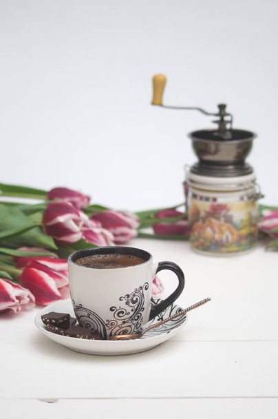 the coffee mug, coffee grinder and tulips to the holiday - Photo, image