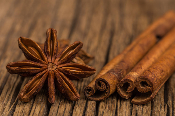 Star anise and cinnamon on old wooden table.  - Photo, image