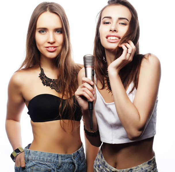 beauty hipster girls with a microphone singing and having fun - Foto, Imagem