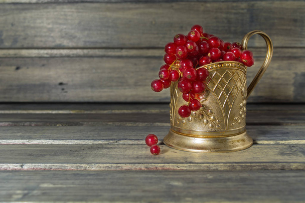 Red currant in the metal glass-holder - Photo, image