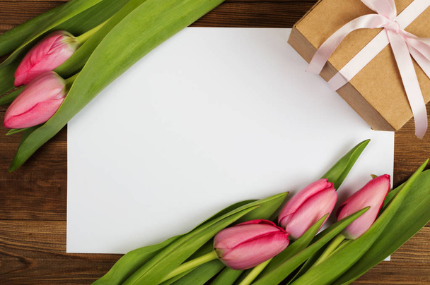 Pink tulips and white paper. Mother's Day. Spring flowers - Photo, Image