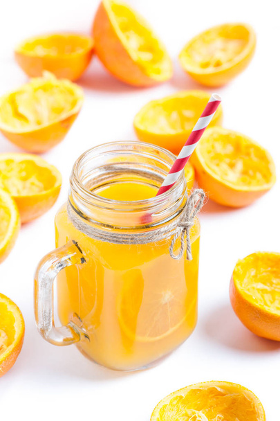 Orange juice isolated on white background with squeezed shells - Photo, Image