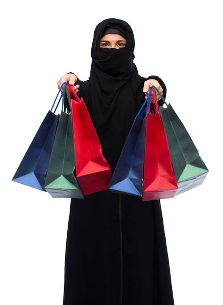 muslim woman in hijab with shopping bags - 写真・画像