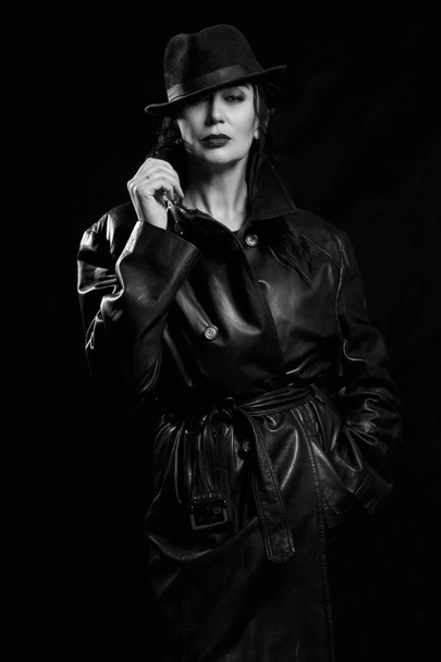 Elegant fashionable woman wearing black coat and hat  - Фото, изображение