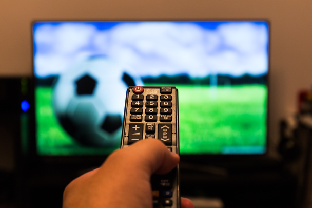 Watching soccer / football game on modern tv, with a close-up of - Photo, Image