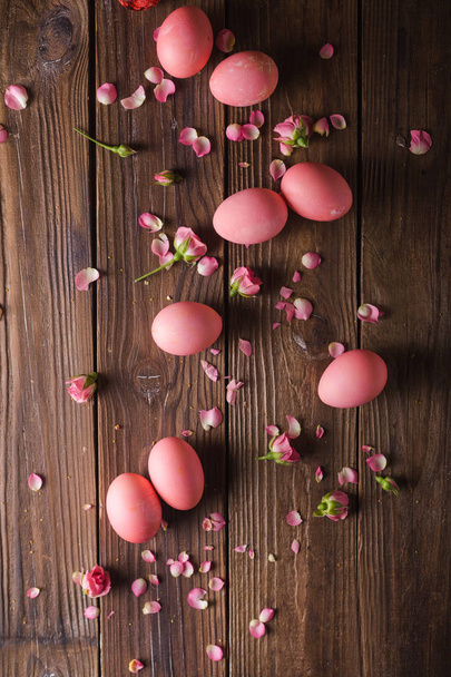 Pink Easter eggs on wodden background. Copyspace. Still life photo of lots of pink easter eggs.Background with easter eggs. Pink eggs and roses. Easter photo concept  - Fotografie, Obrázek