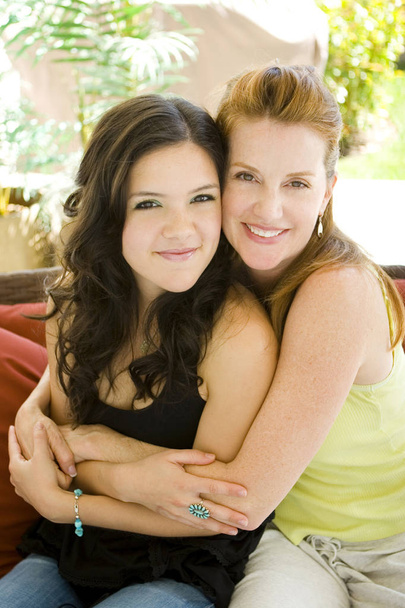 Beautiful mother and daughter smiling and hugging. - Photo, image