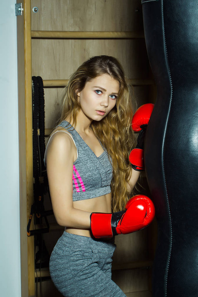 Pretty girl boxer punching - Фото, изображение