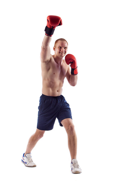 Full length portrait of young male boxer flexing muscles isolated over white background - Fotografie, Obrázek