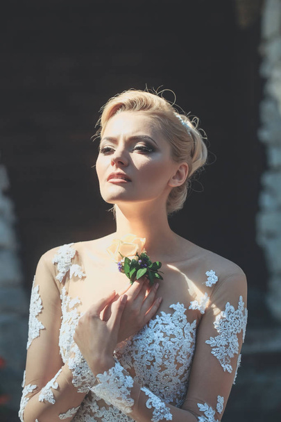 Pretty bride in wedding dress with flower - Foto, immagini
