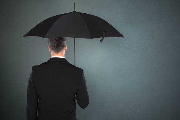 Businessman Holding Umbrella - Фото, зображення