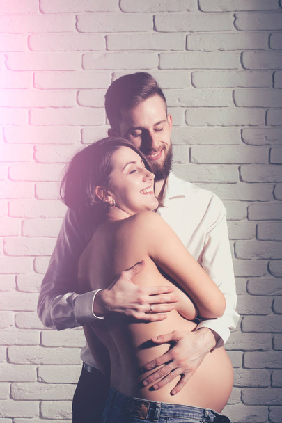 bearded man and pretty pregnant woman with naked round belly - Foto, Bild