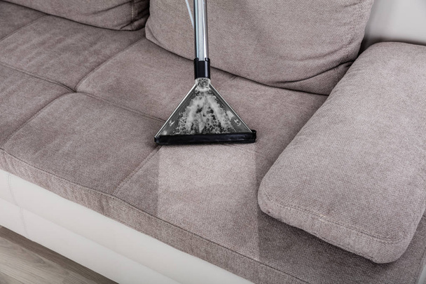 Cleaning Sofa With Vacuum Cleaner - Valokuva, kuva