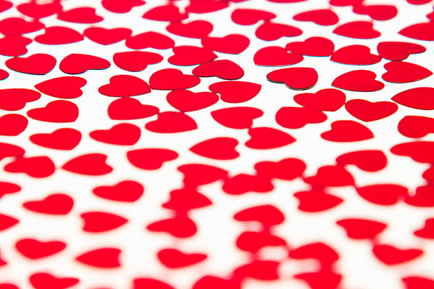 Valentines day pattern of red hearts confetti with blur on white background. - Fotoğraf, Görsel