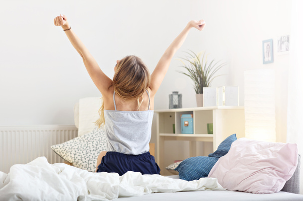 Happy woman stretching in the morning - 写真・画像