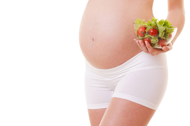 Healthy nutrition of pregnant woman. White background. Close up. Motherhood, pregnancy, people and expectation concept. Pregnant woman expecting baby - Fotografie, Obrázek