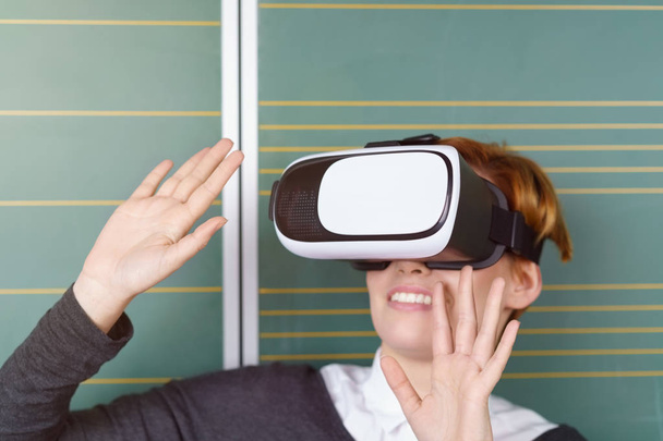 Impressed woman in VR headset - 写真・画像