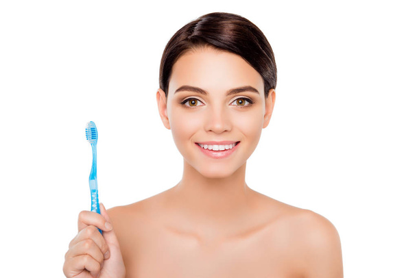 Pretty young woman with beaming smile holding toothbrush - Fotoğraf, Görsel