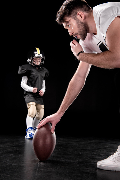 Boy playing football with trainer - Fotografie, Obrázek