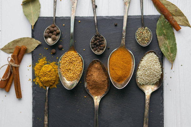  spoons with different colored spices - Foto, imagen