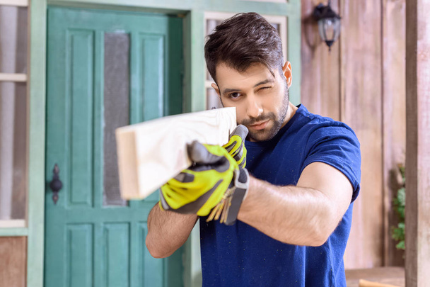 carpenter working with wooden plank - Photo, Image