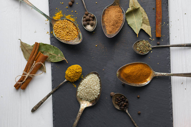  spoons with different colored spices - Foto, Imagen