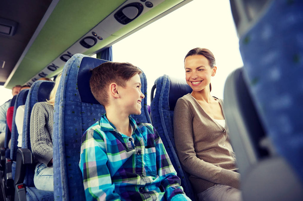 happy family riding in travel bus - Fotó, kép