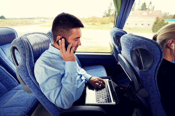 man with smartphone and laptop in travel bus - Fotoğraf, Görsel