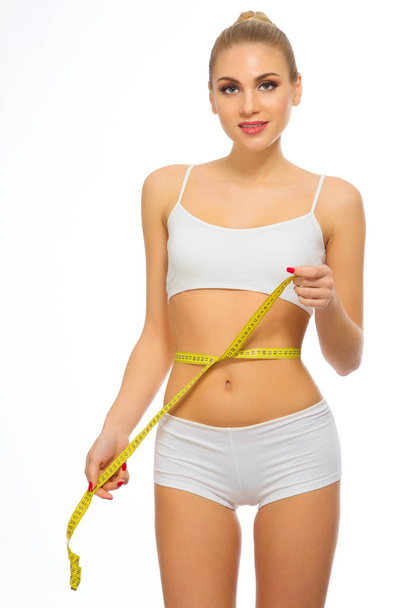 Young woman with measurement tape - Foto, imagen