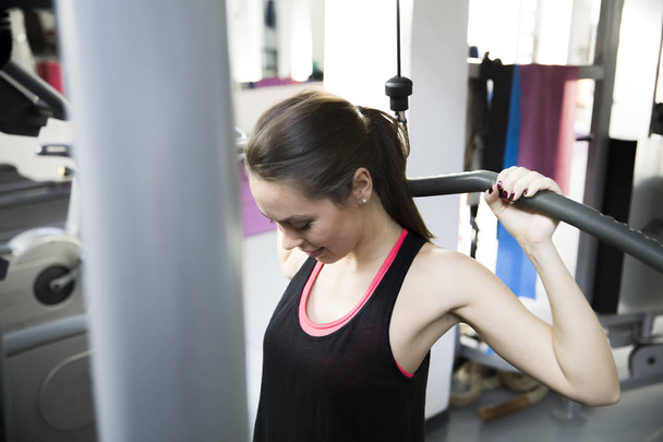 Young woman exercising in the gym - Photo, image