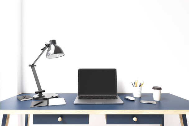 Laptop monitor on a blue desk - Foto, afbeelding