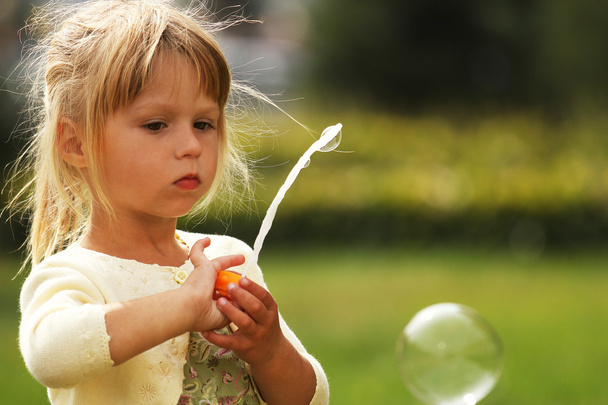 Little girl with soap bubbles - Fotó, kép