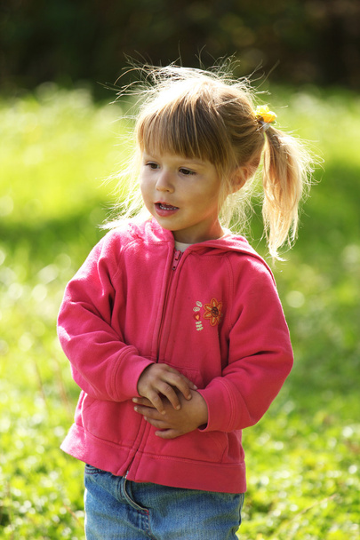 Beautiful little girl outdoors near a lake in rubber boots - Valokuva, kuva