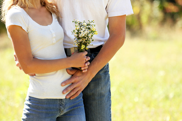 Couple in love with flowers in nature - Valokuva, kuva