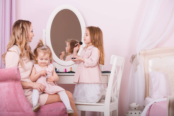Mother and two daughters doing lip make-up. - Φωτογραφία, εικόνα