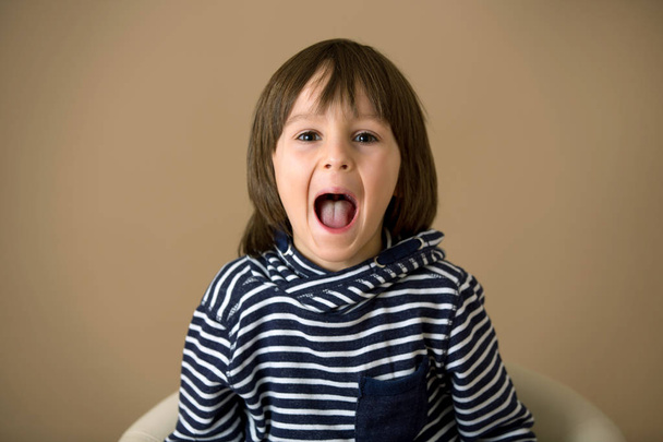 Sweet preschool boy, making faces with different emotion - Fotografie, Obrázek