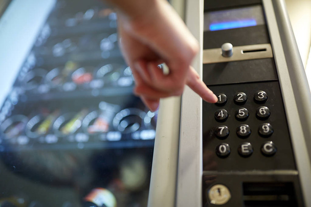 hand pushing button on vending machine keyboard - Photo, image